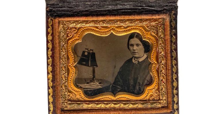 Woman with a stereoscope — cased Ambrotype